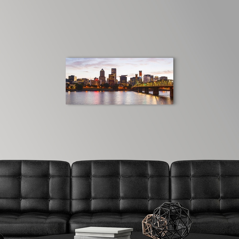 A modern room featuring Panoramic photograph of the Portland, Oregon skyline lit up with yellow lights at the beginning o...