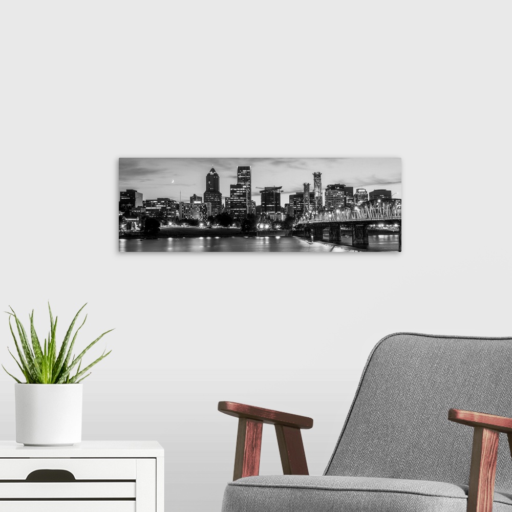 A modern room featuring Panoramic photograph of the Portland, Oregon skyline lit up with lights at the beginning of sunse...