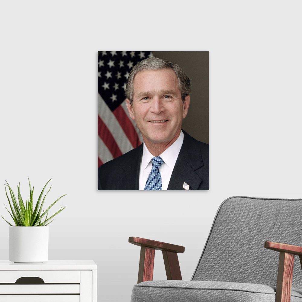 A modern room featuring President Bush poses for his official portrait in the Roosevelt Room, wearing a blue tie. Library...