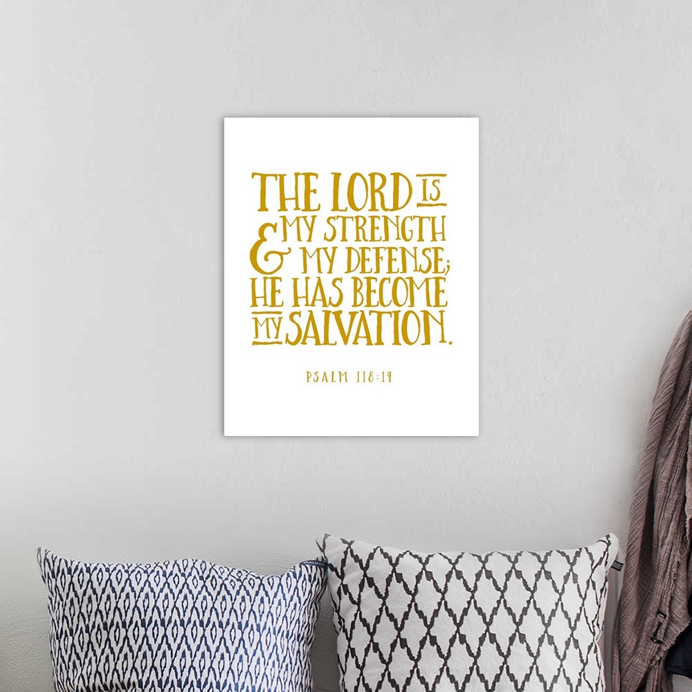 A bohemian room featuring Handlettered Bible verse reading The Lord is my strength and my defense; He has become my salvation.
