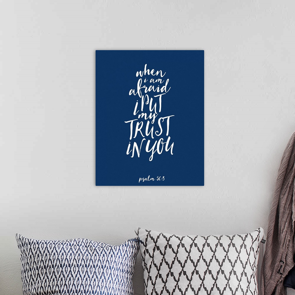 A bohemian room featuring Handlettered Bible verse reading When I am afraid I put my trust in You.