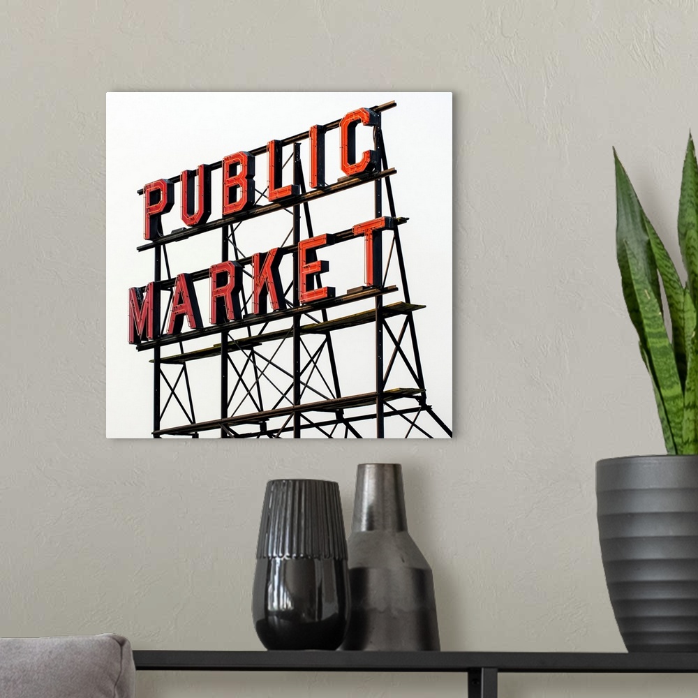 A modern room featuring Square photograph of the red Public Market sign at Pike Place Market in downtown Seattle, WA.