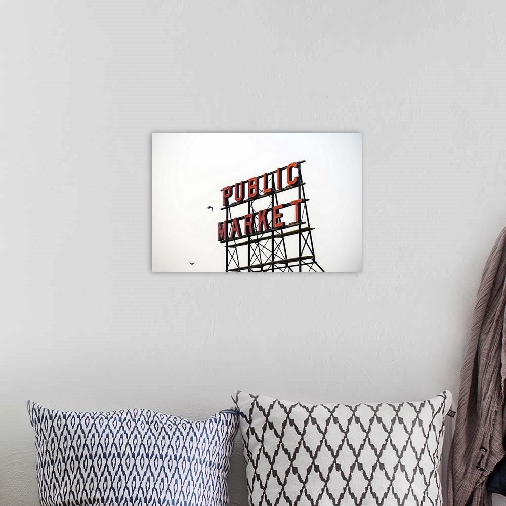 A bohemian room featuring Photograph of the red Public Market sign  at the farmers market in downtown Seattle with two bird...