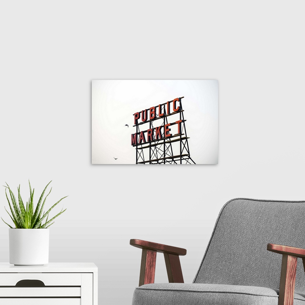 A modern room featuring Photograph of the red Public Market sign  at the farmers market in downtown Seattle with two bird...