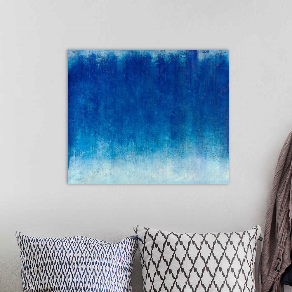 A bohemian room featuring A horizontal monochromatic abstract painting with beautiful textures.