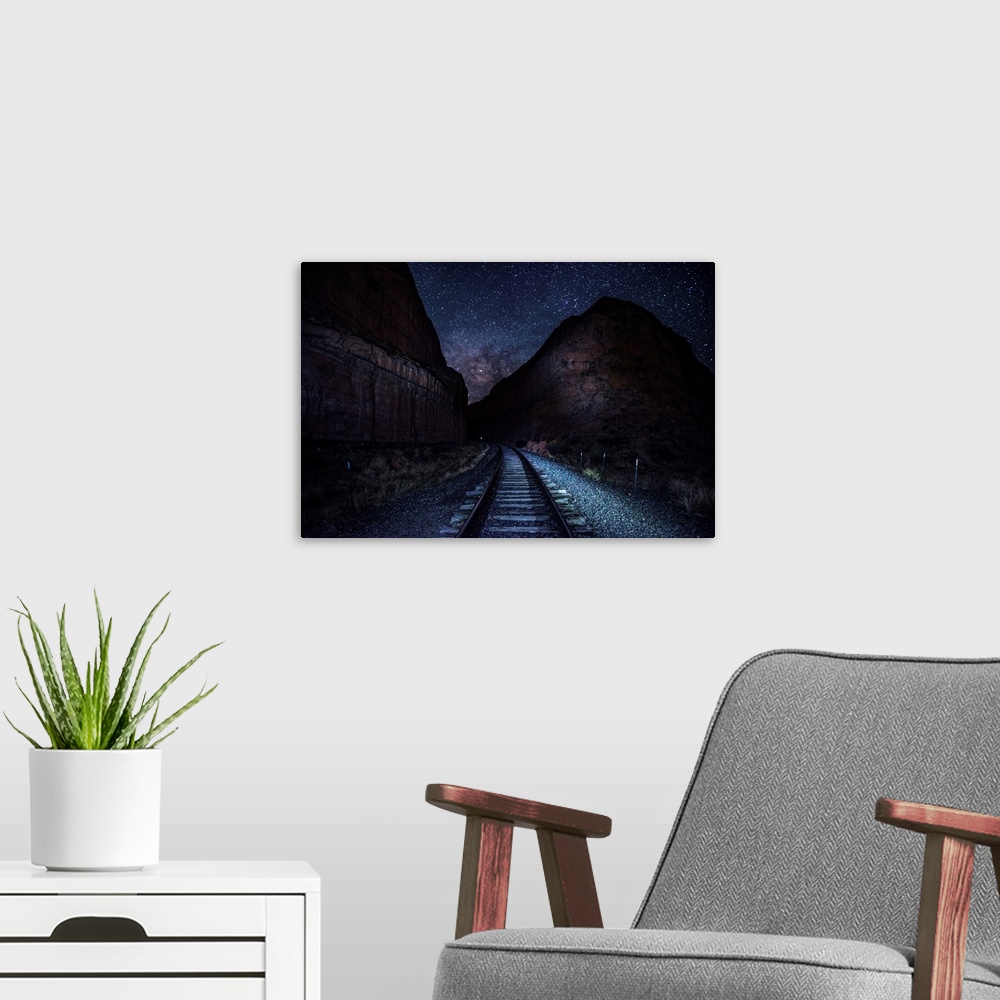 A modern room featuring View of railroad tracks at night with a starry sky above near Arches National Park in Utah.