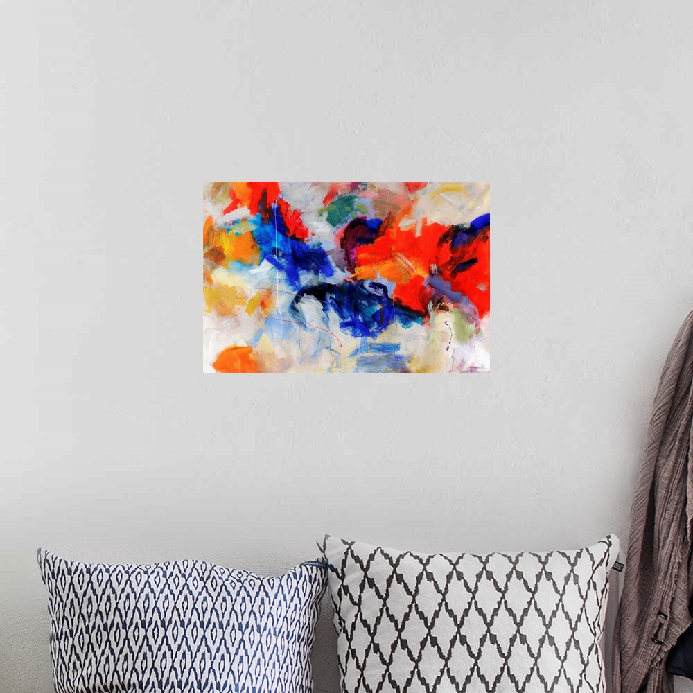 A bohemian room featuring Wall art of an abstractly painted canvas of different blotches of bright colors put together.