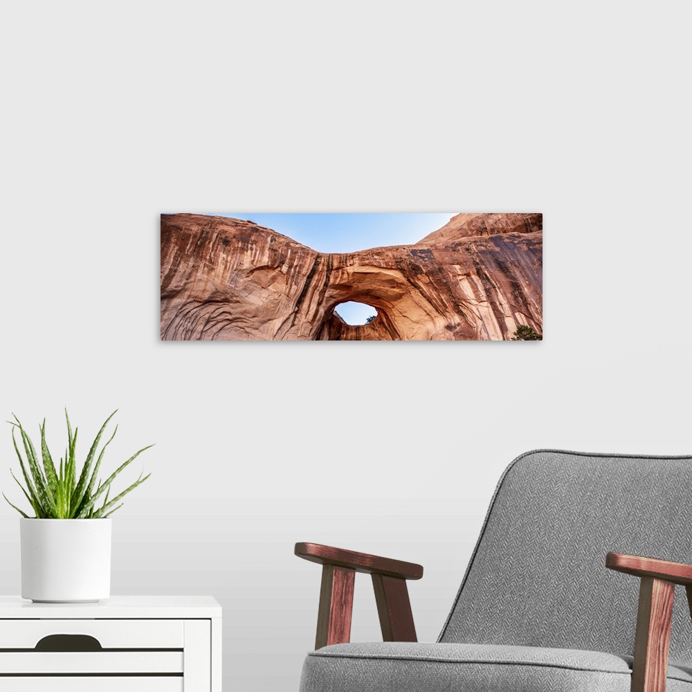 A modern room featuring Bright red rock contrasting with the blue sky at the Bowtie Arch, Arches National Park, Utah.