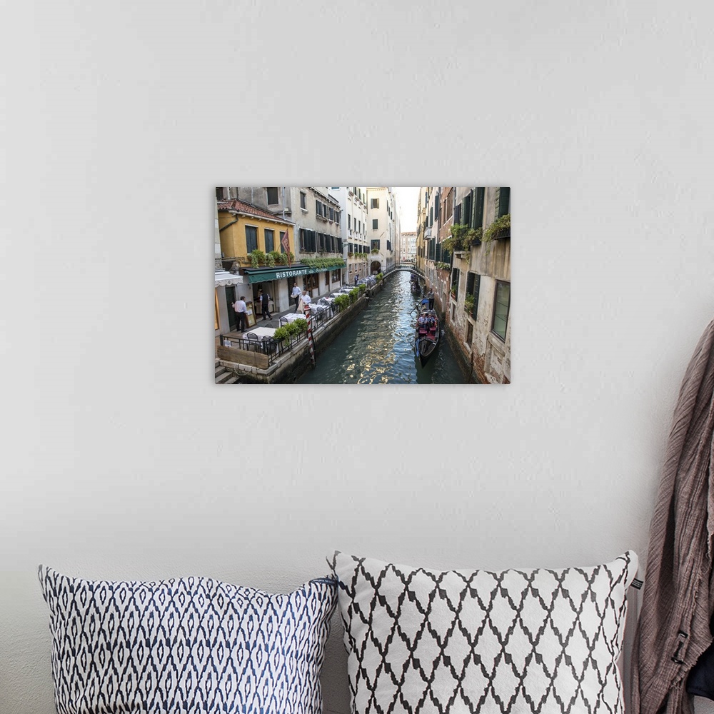 A bohemian room featuring Photograph of a canal in Venice with gondolas in a row, rowing by Ristorante Da Raffaele.