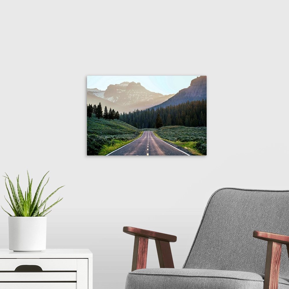 A modern room featuring Horizontal image of a road heading to the mountains at Yellowstone National Park.