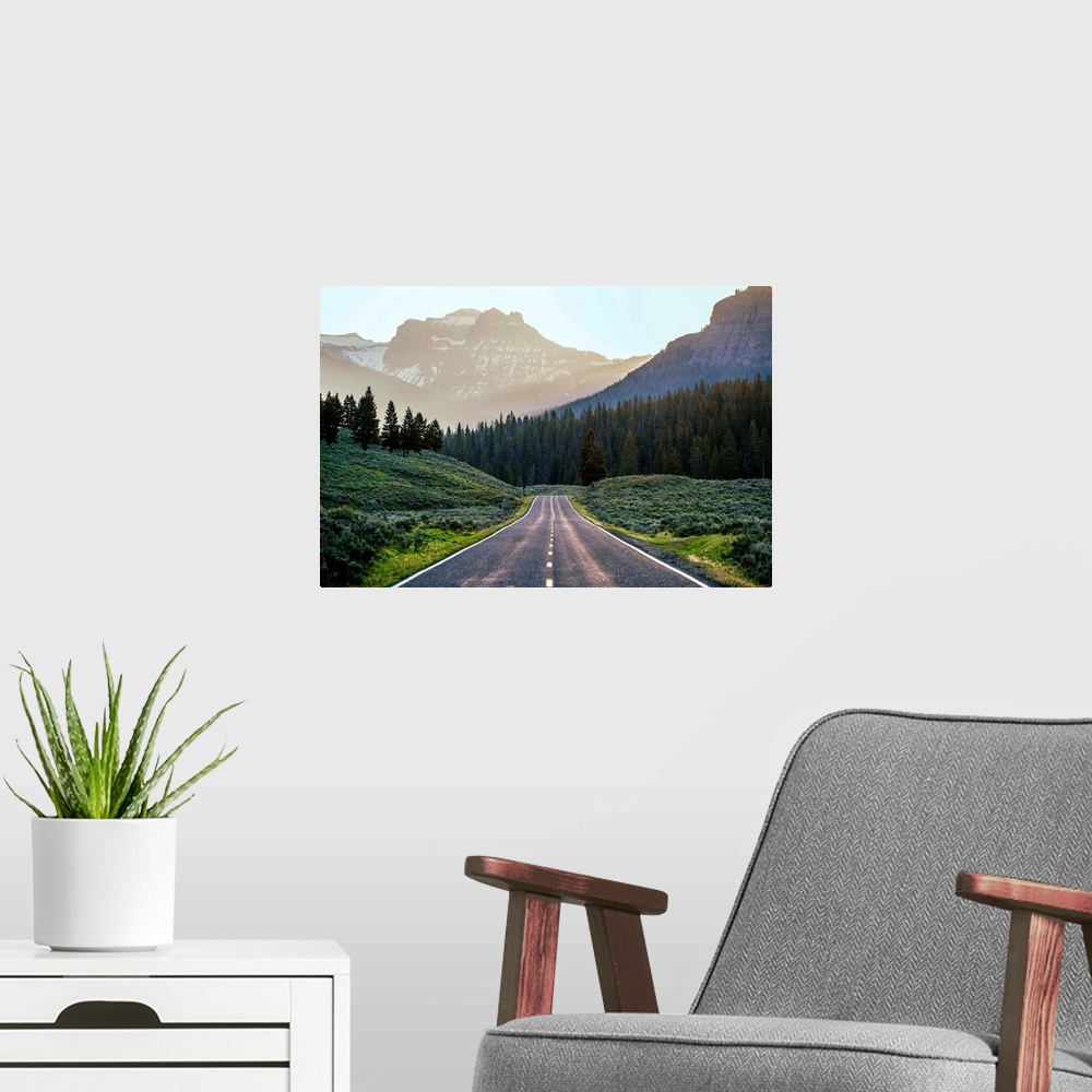 A modern room featuring Horizontal image of a road heading to the mountains at Yellowstone National Park.