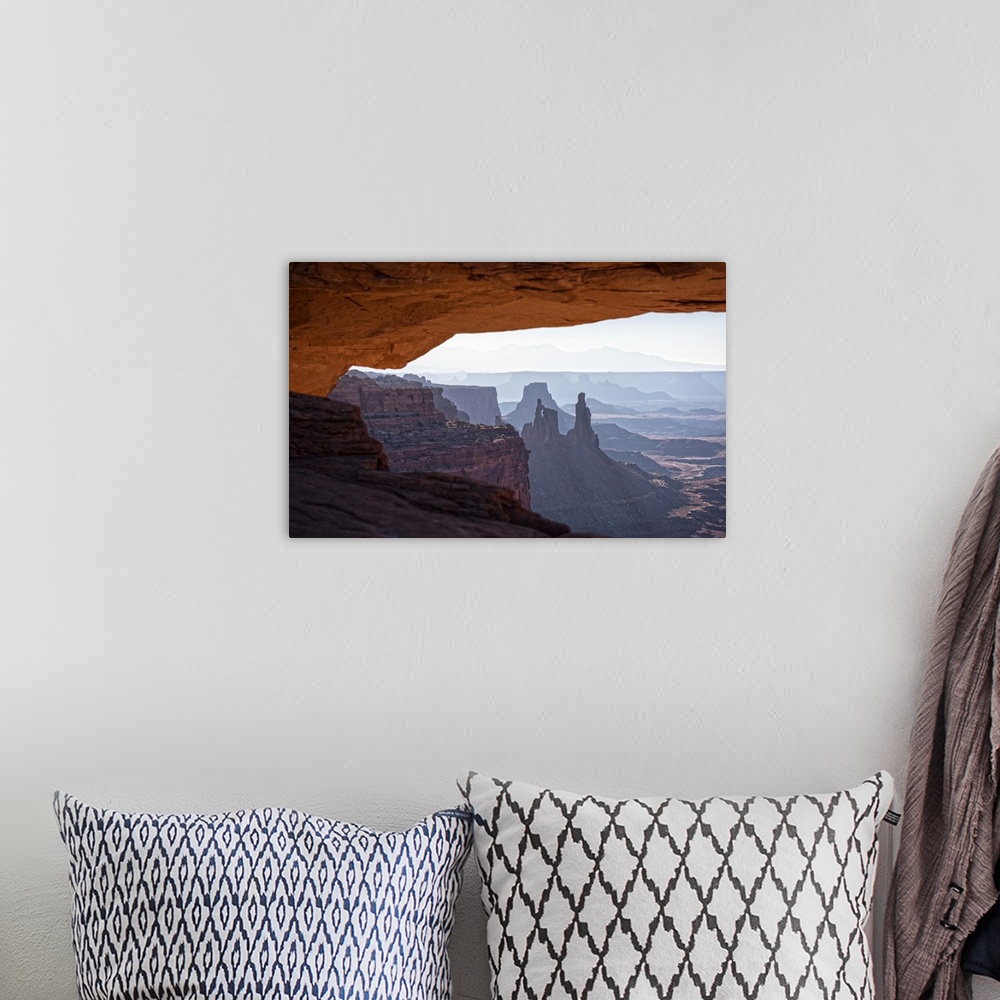 A bohemian room featuring View of the desert landscape of Buck Canyon from under the Mesa Arch, Canyonlands National Park, ...