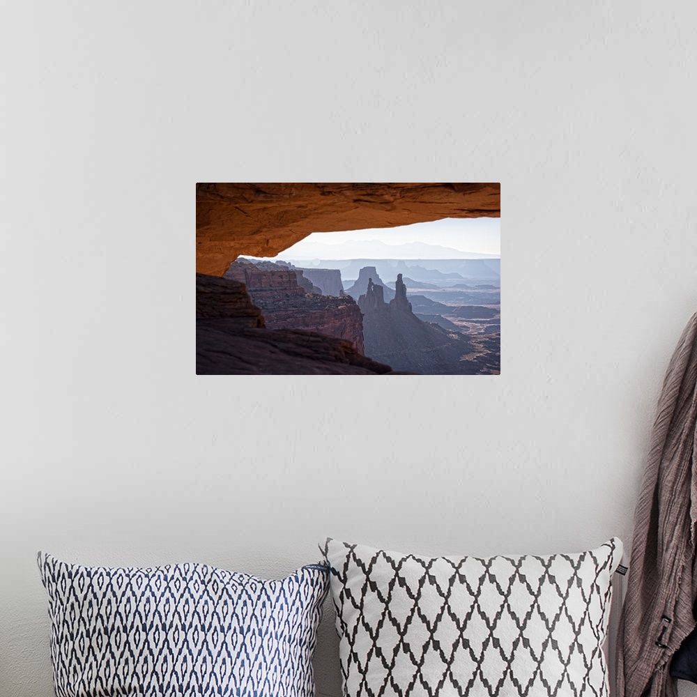 A bohemian room featuring View of the desert landscape of Buck Canyon from under the Mesa Arch, Canyonlands National Park, ...