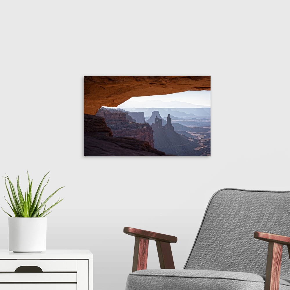 A modern room featuring View of the desert landscape of Buck Canyon from under the Mesa Arch, Canyonlands National Park, ...