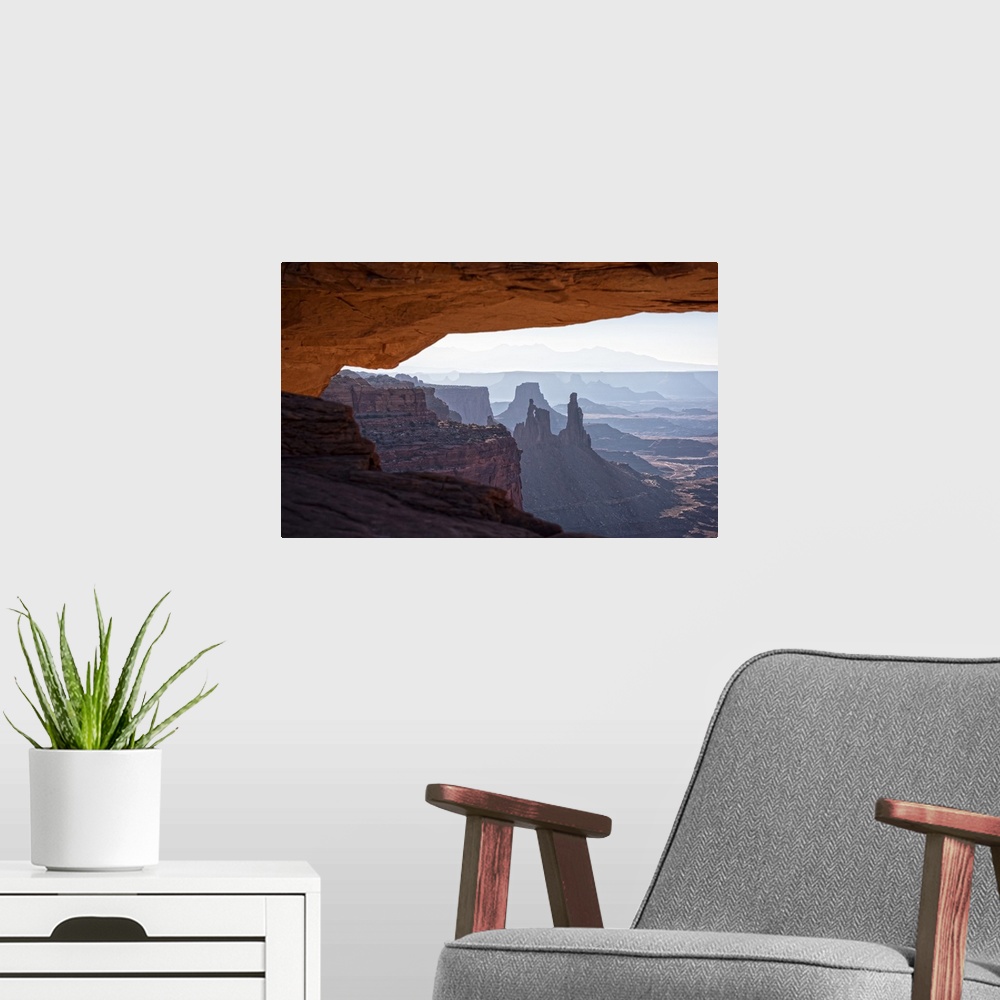 A modern room featuring View of the desert landscape of Buck Canyon from under the Mesa Arch, Canyonlands National Park, ...