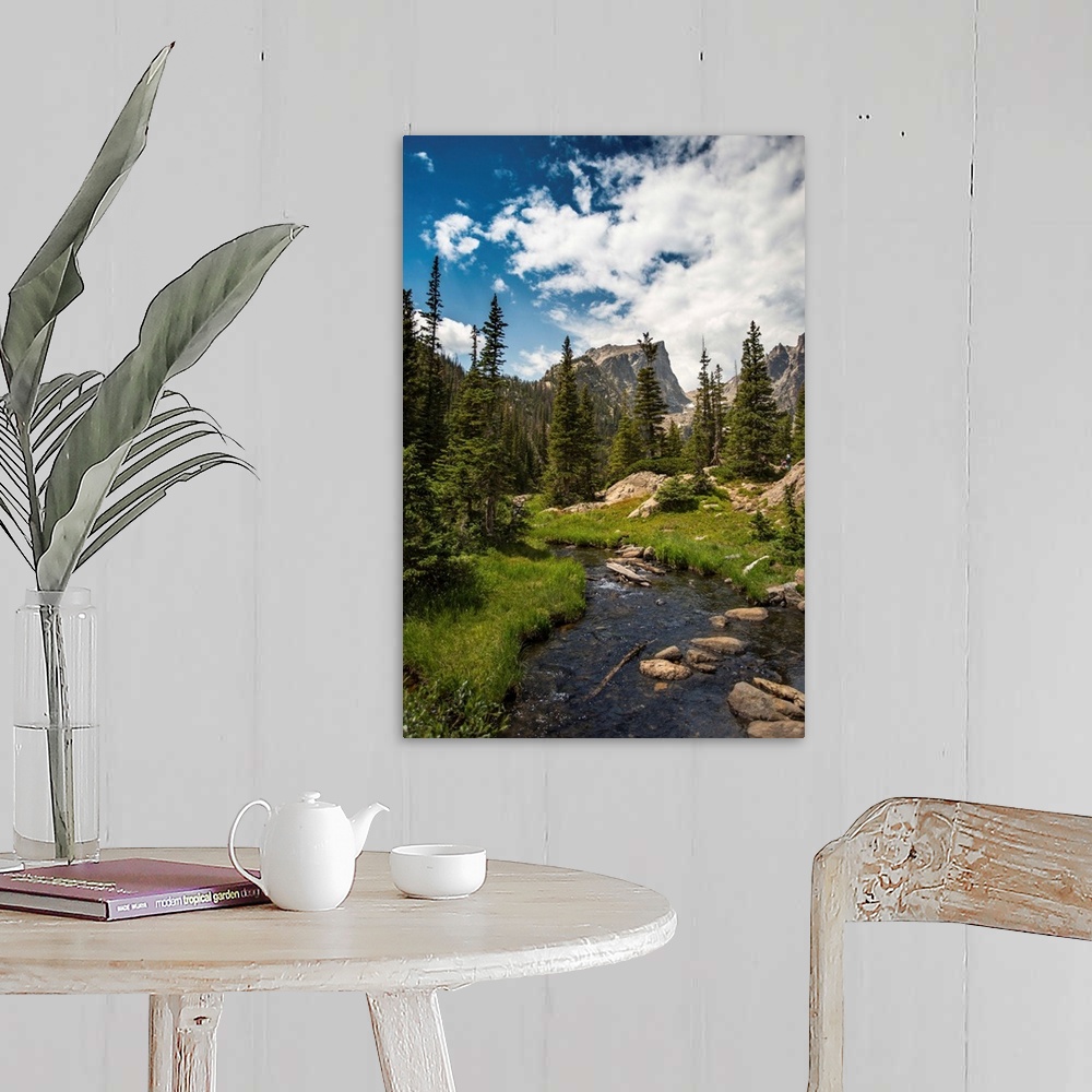 A farmhouse room featuring Landscape photograph of a stream going through Rocky Mountain National Park on a beautiful day.
