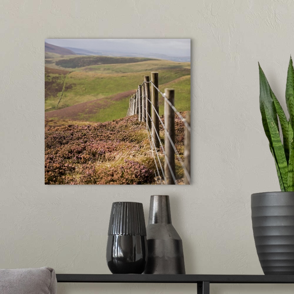 A modern room featuring Square photograph of a fence running though rolling hills in an Edinburgh countryside, Scotland, UK