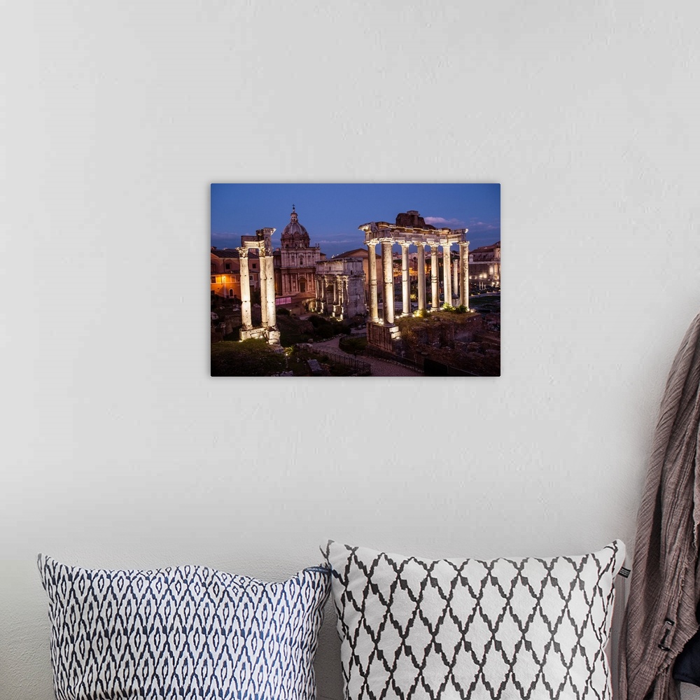 A bohemian room featuring Photograph of the ruins at the Roman Forum lit up at night.