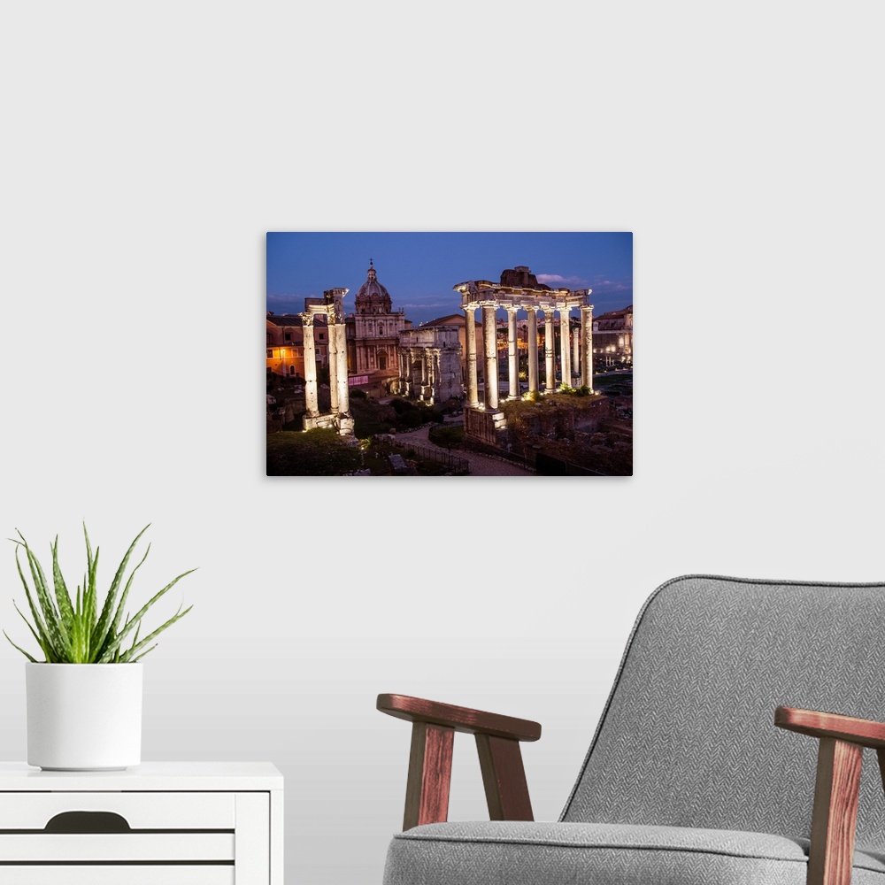 A modern room featuring Photograph of the ruins at the Roman Forum lit up at night.