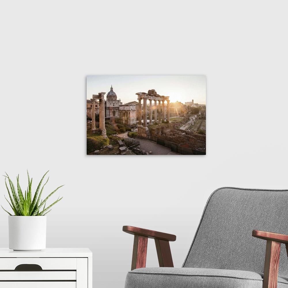 A modern room featuring Photograph of the ruins at the Roman Forum with the sun shining in the background.