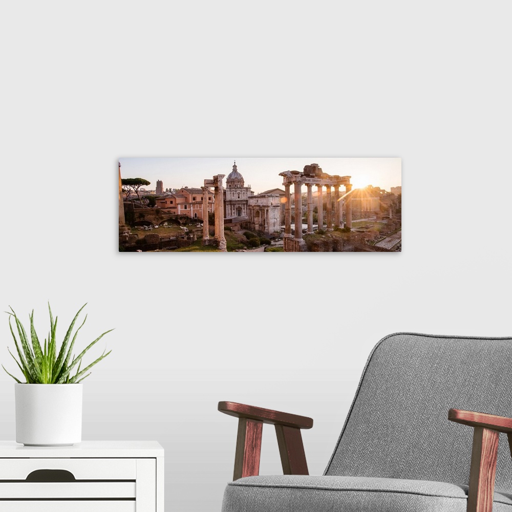 A modern room featuring Panoramic photograph of the ruins at the Roman Forum with the sun shining in the background.