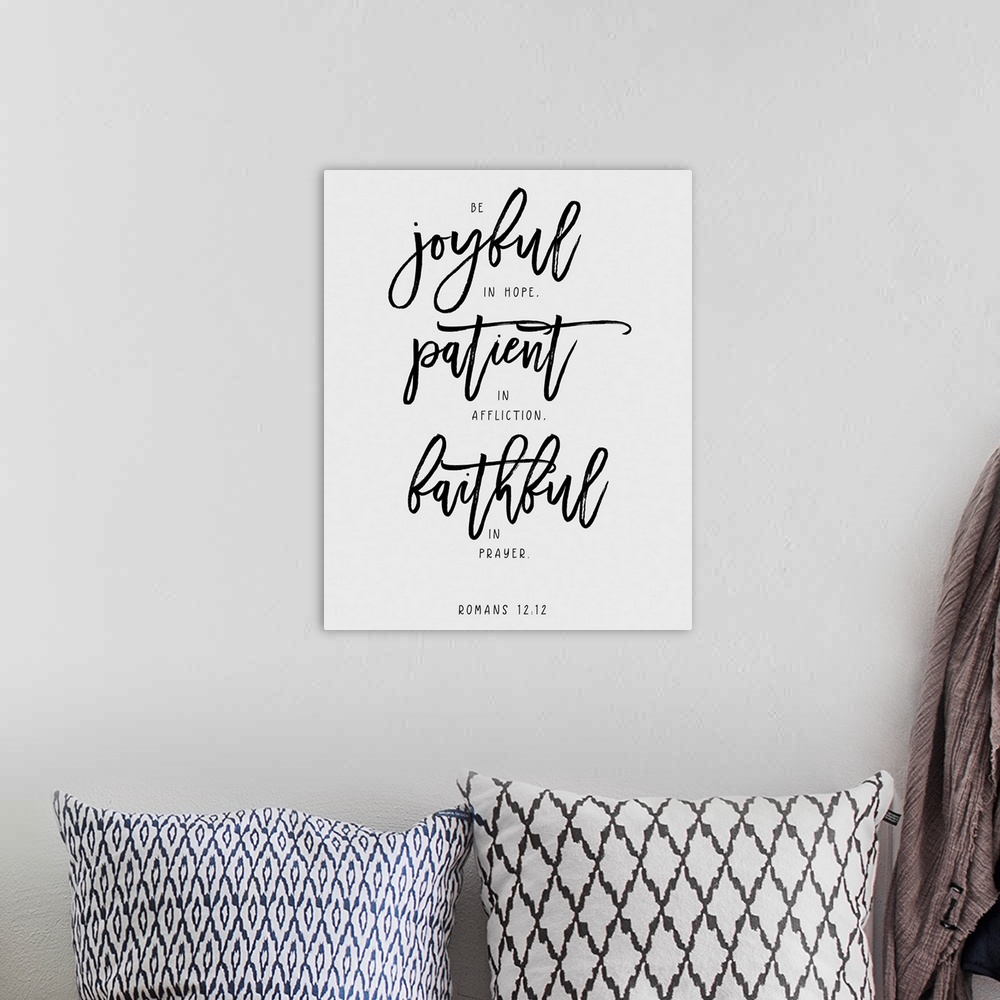A bohemian room featuring Handlettered Bible verse reading The Lord is my strength and my defense; He has become my salvation.