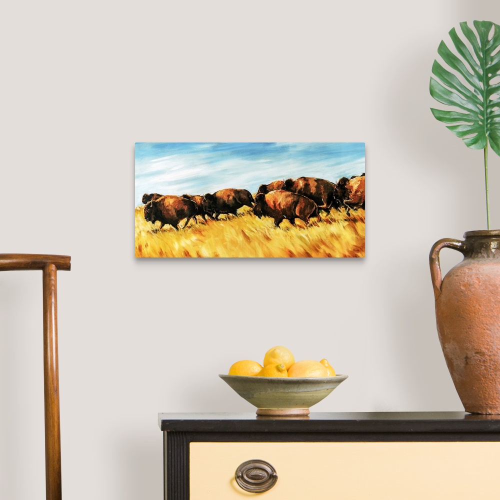 A traditional room featuring Painting of a herd of buffalo running wild on a grassy plain.