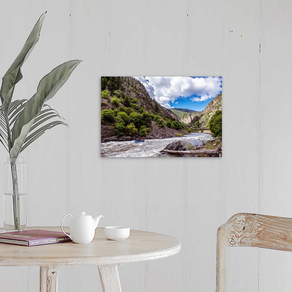 A farmhouse room featuring Photo of a rushing river under a mountain cliffside in Colorado.