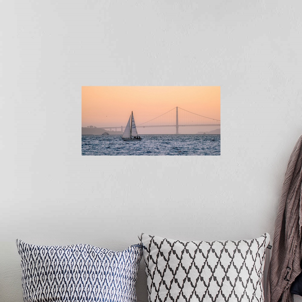 A bohemian room featuring A lone sailboat floats in the pacific ocean with Golden Gate bridge in the background, San Franci...