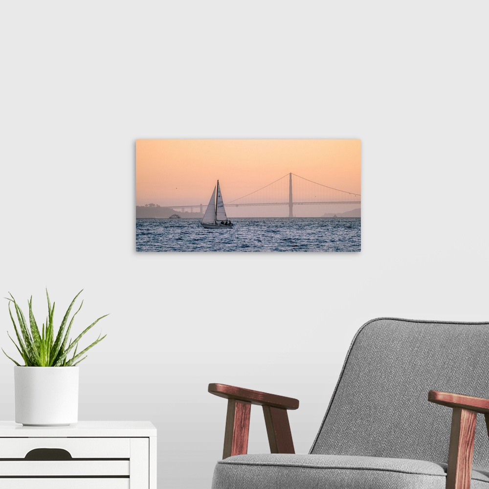 A modern room featuring A lone sailboat floats in the pacific ocean with Golden Gate bridge in the background, San Franci...