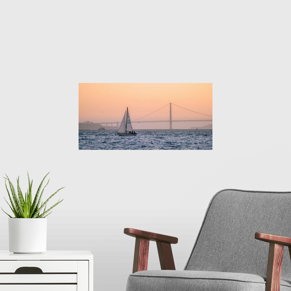 A modern room featuring A lone sailboat floats in the pacific ocean with Golden Gate bridge in the background, San Franci...
