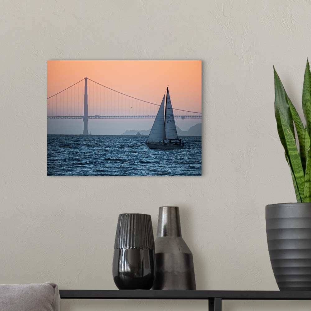 A modern room featuring Sunset photograph of a sailboat on the San Francisco Bay with the Golden Gate Bridge in the backg...