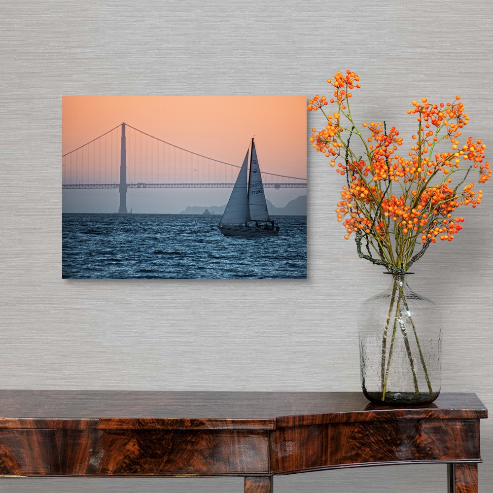 A traditional room featuring Sunset photograph of a sailboat on the San Francisco Bay with the Golden Gate Bridge in the backg...