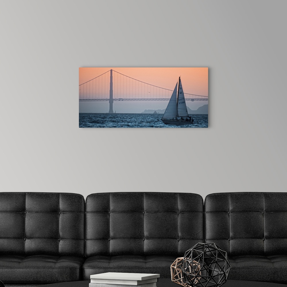 A modern room featuring Sunset photograph of a sailboat on the San Francisco Bay with the Golden Gate Bridge in the backg...