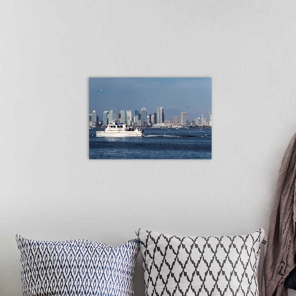 A bohemian room featuring Photograph of a charter fishing boat on the Pacific Ocean with seagulls flying around it and the ...