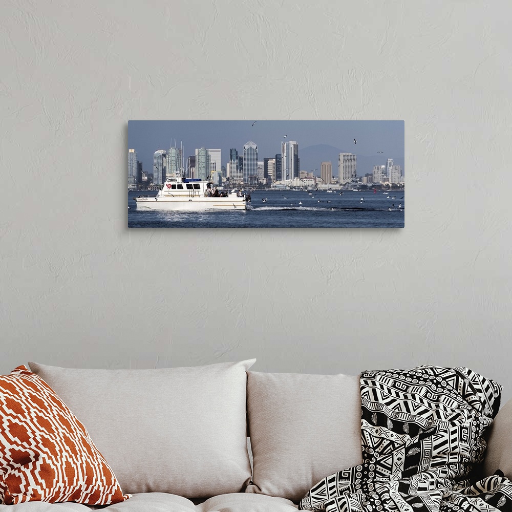 A bohemian room featuring Panoramic photograph of a charter fishing boat on the Pacific Ocean with seagulls flying around i...