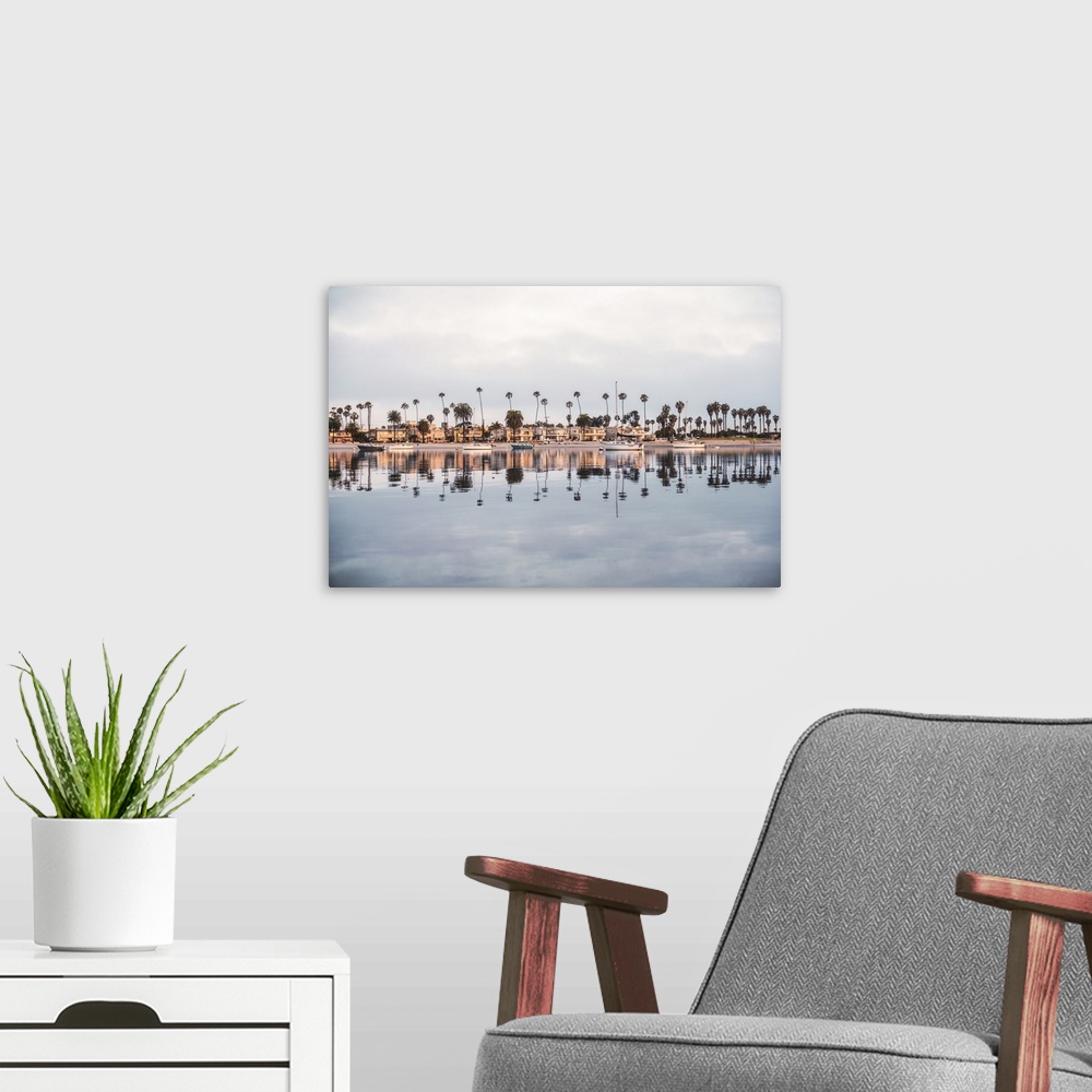 A modern room featuring Photograph of beach houses, palm trees, and boats on the San Diego coast reflecting into the water.
