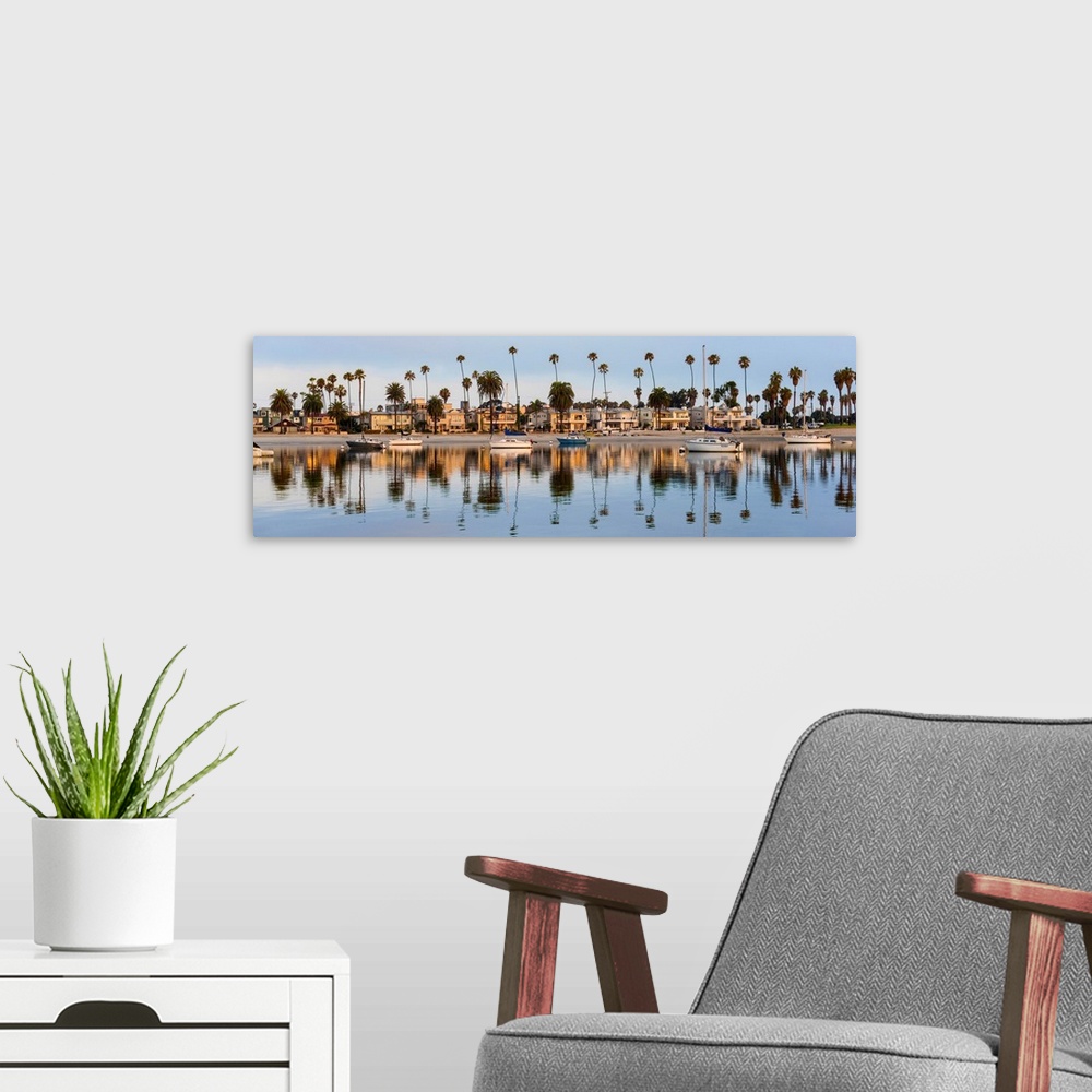 A modern room featuring Panoramic photograph of beach houses, palm trees, and boats on the San Diego coast reflecting int...