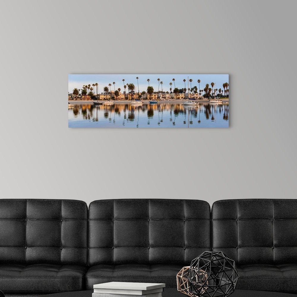 A modern room featuring Panoramic photograph of beach houses, palm trees, and boats on the San Diego coast reflecting int...