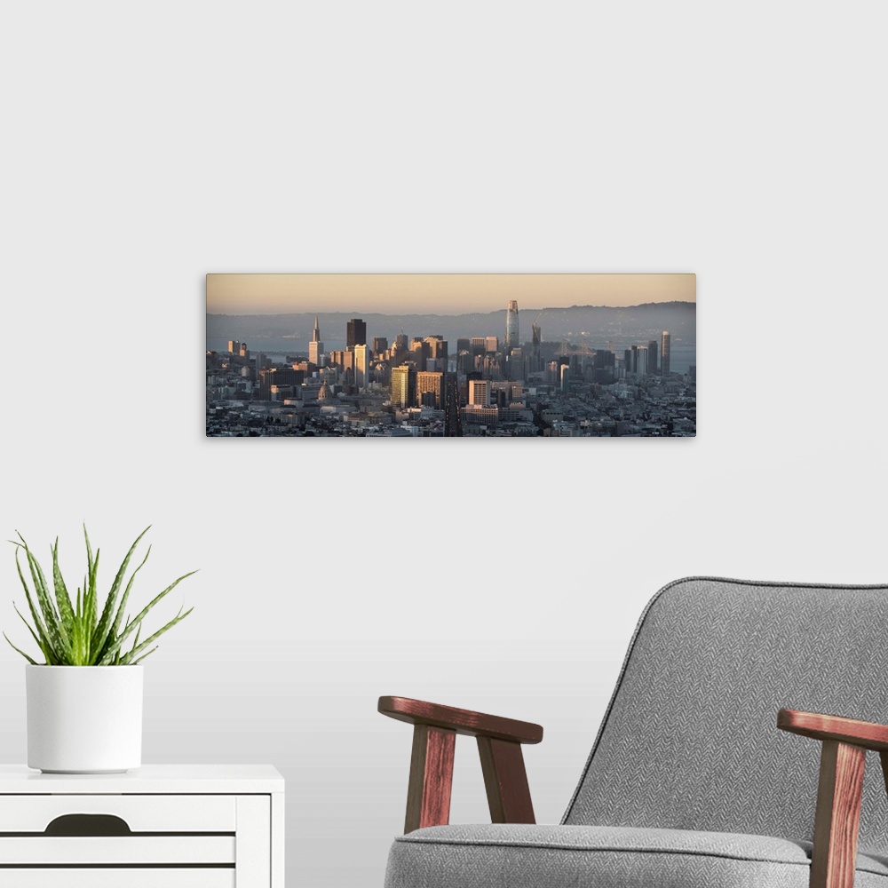 A modern room featuring Panoramic photograph of the San Francisco skyline close to sunset.