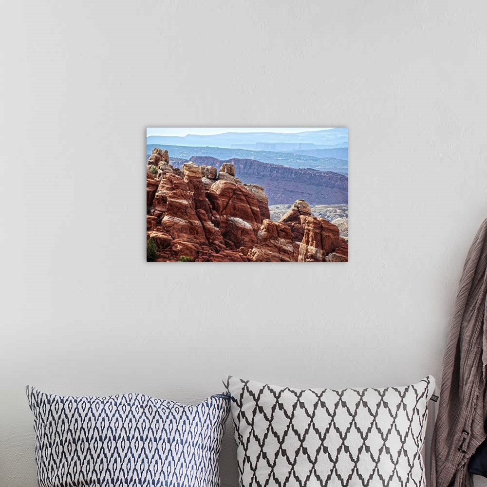 A bohemian room featuring Sandstone formations in the Fiery Furnace, overlooking the Salt Valley with the La Sal mountains ...
