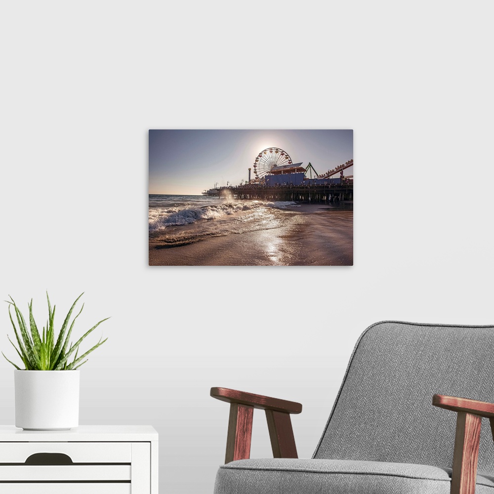 A modern room featuring Photograph of the Santa Monica Pier in Los Angeles, California, with the sun setting right behind...
