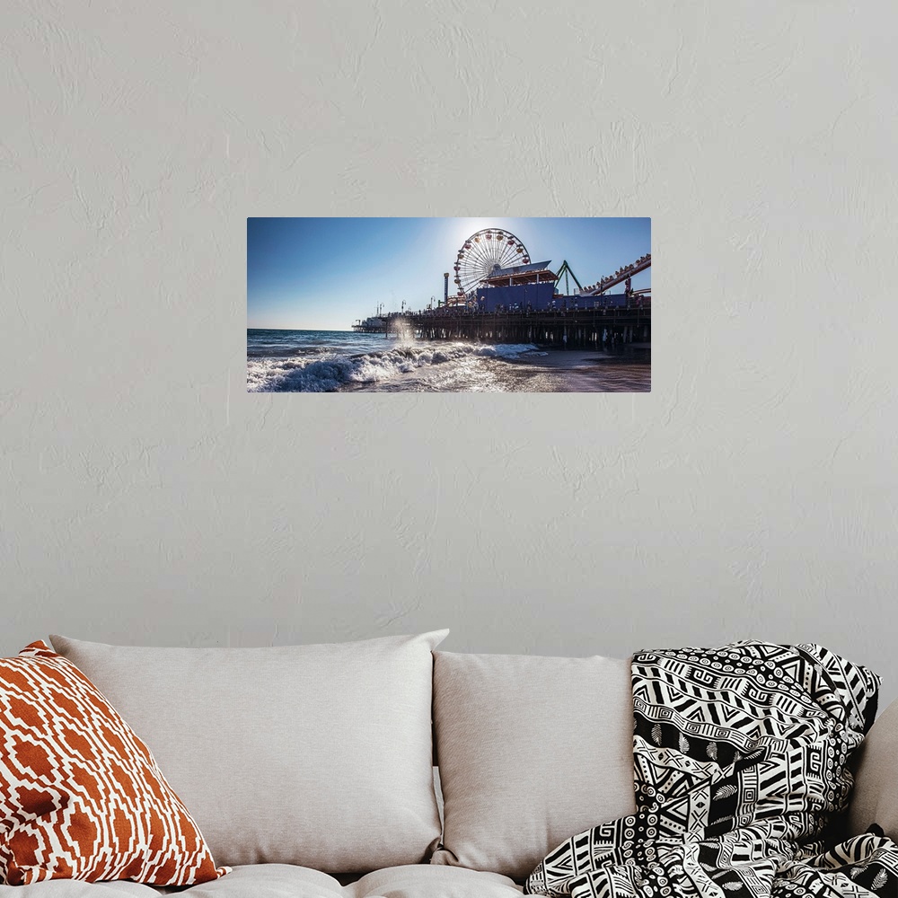 A bohemian room featuring Panoramic photograph of the Santa Monica Pier in Los Angeles, California, with the sun setting ri...