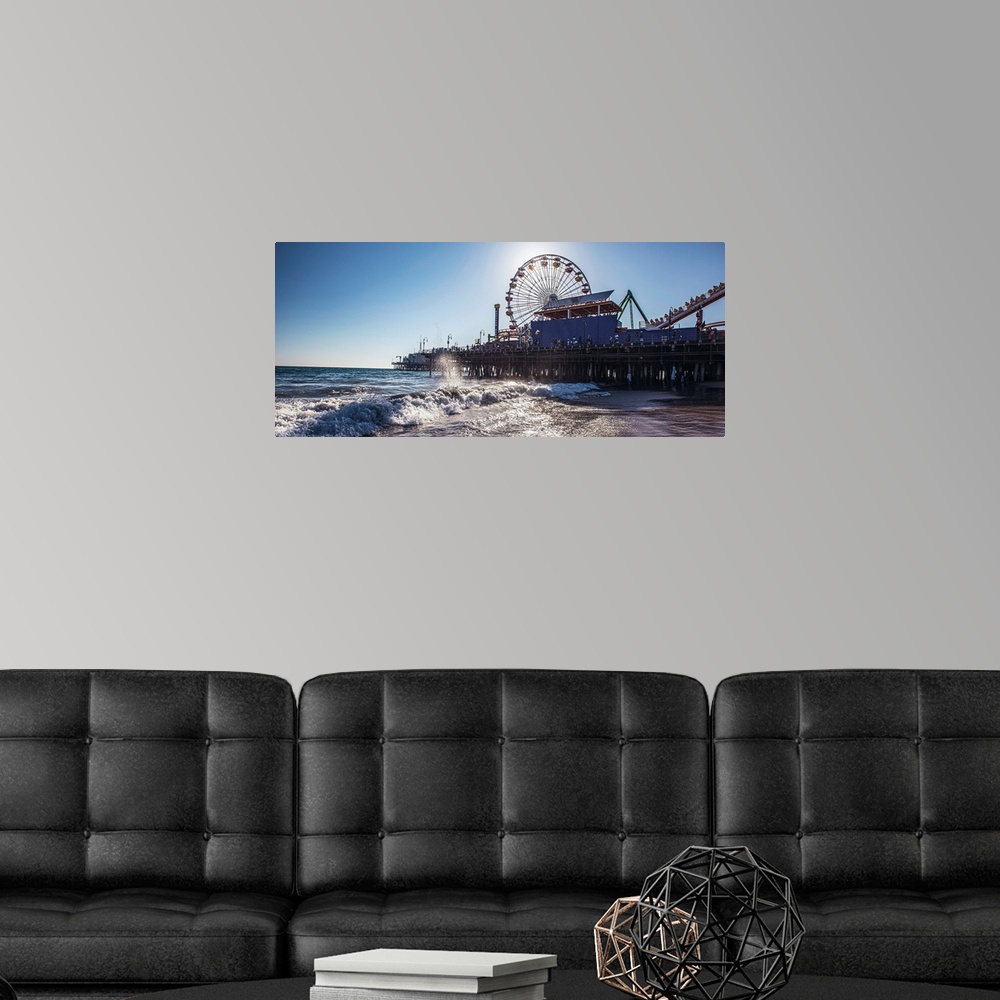 A modern room featuring Panoramic photograph of the Santa Monica Pier in Los Angeles, California, with the sun setting ri...
