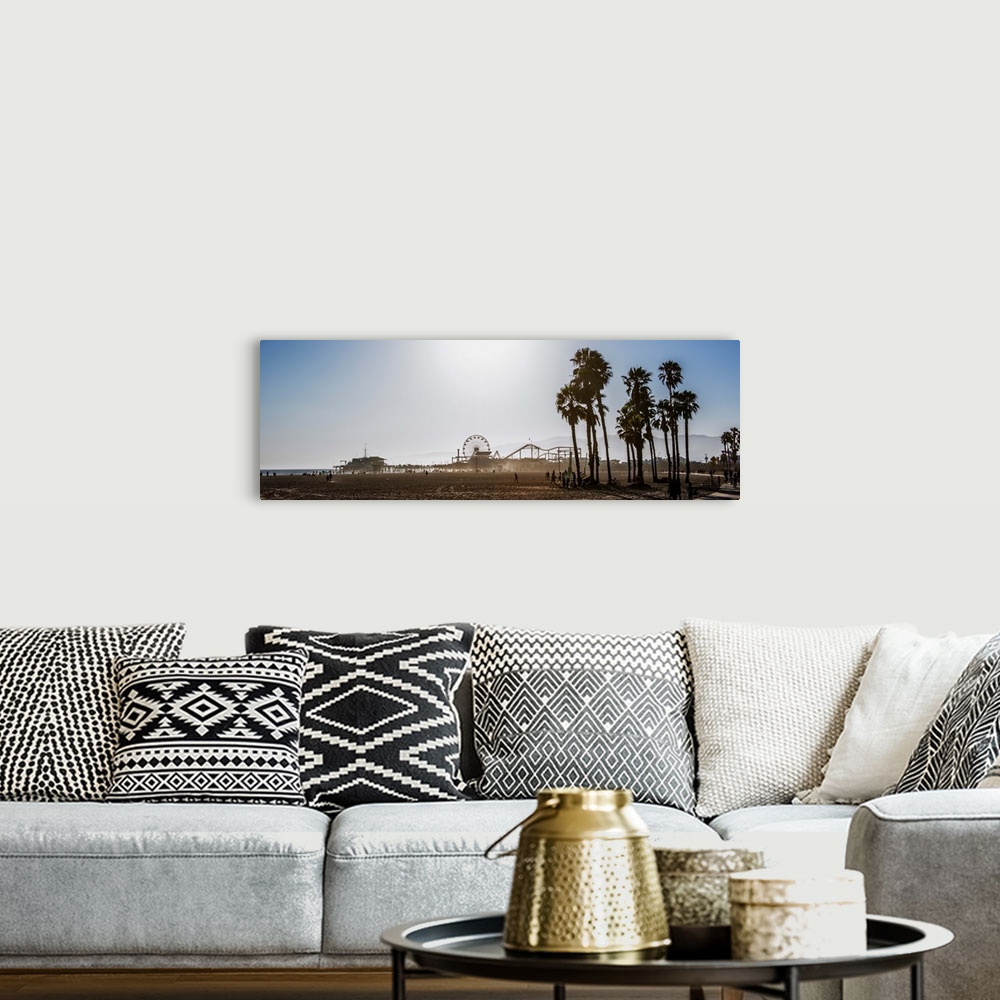 A bohemian room featuring Panoramic photograph of the Santa Monica Pier in Los Angeles, California, with palm trees in the ...