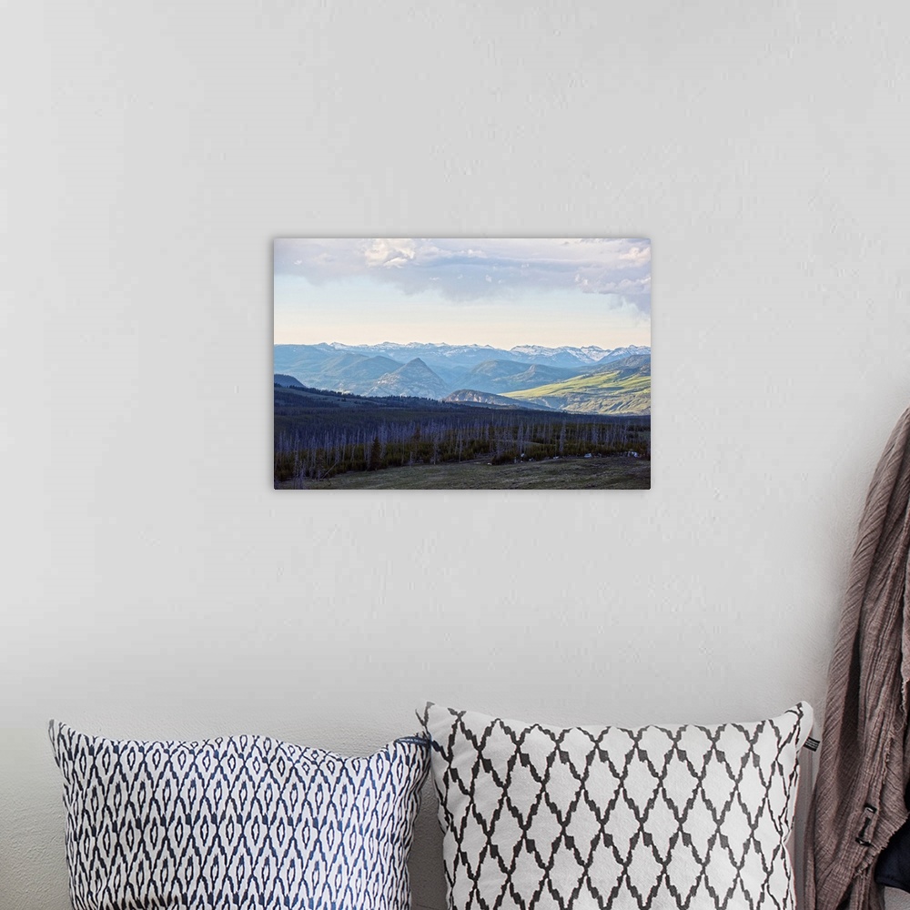 A bohemian room featuring A scenic view of wilderness and Rocky Mountains in Yellowstone National Park.