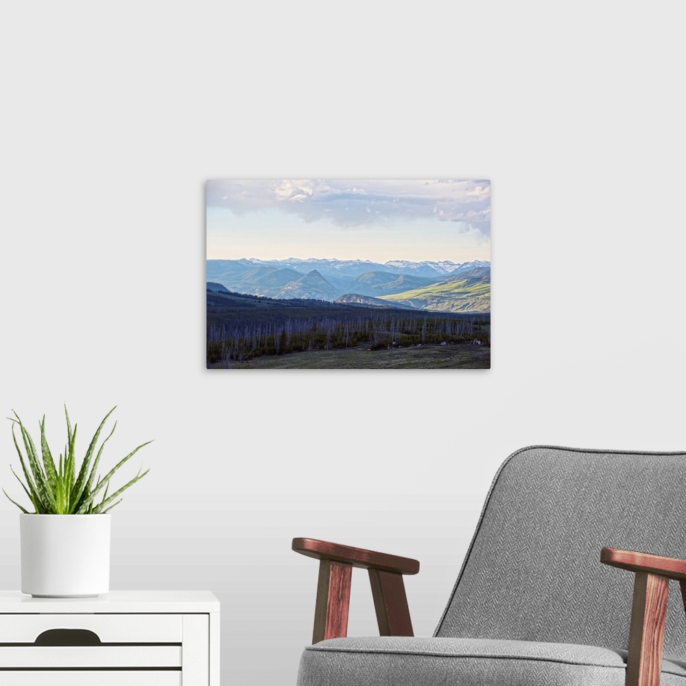 A modern room featuring A scenic view of wilderness and Rocky Mountains in Yellowstone National Park.