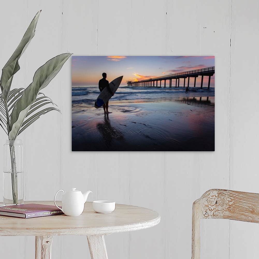 A farmhouse room featuring Silhouetted photograph of a man holding a surf board on the shore of Ocean Beach in San Diego, Ca...