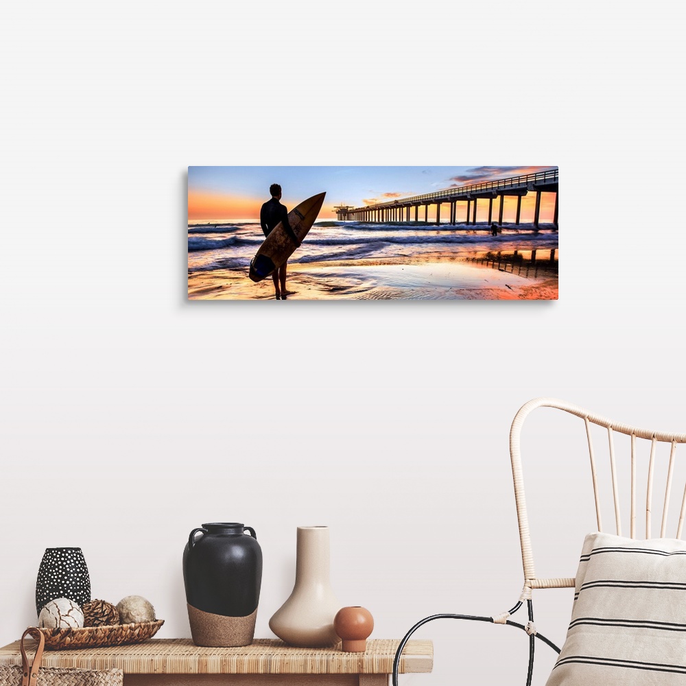 A farmhouse room featuring Silhouetted panoramic photograph of a man holding a surf board on the shore of Scripps Beach in S...