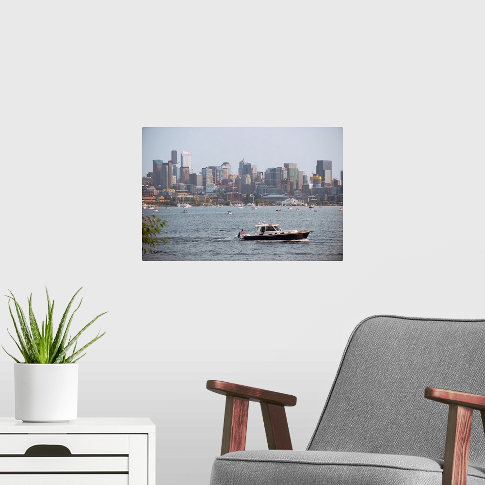 A modern room featuring A boat passes by with Seattle's city skyline in the background. View from Lake Union, Washington.
